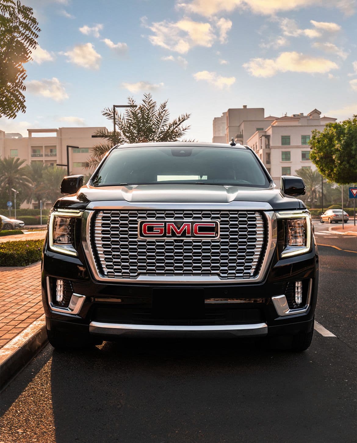 Luxury black GMC SUV on a road